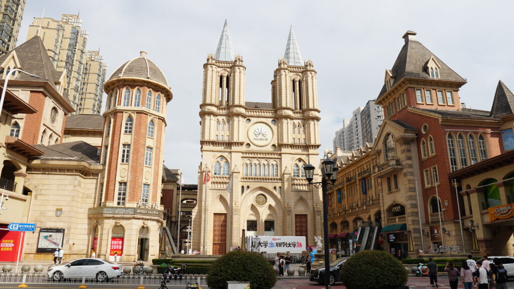 A large building with two clock towers in Wuhan, rising high into the sky.