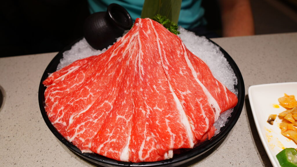 Large pieces of raw meat on ice at Haidilao Hotpot in Wuhan.