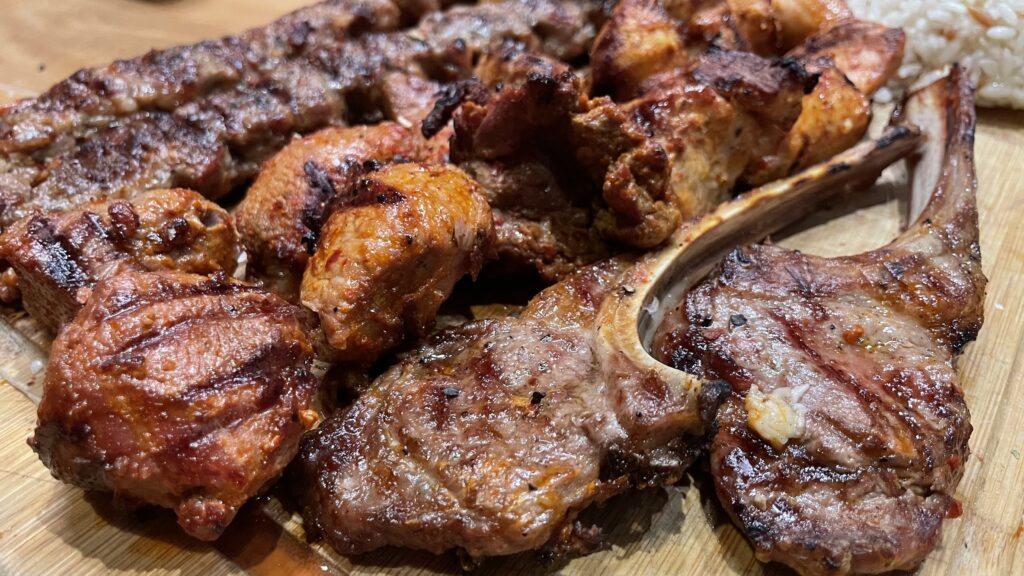 Authentic Turkish grilled meat and rice on a wooden cutting board in Frankfurt