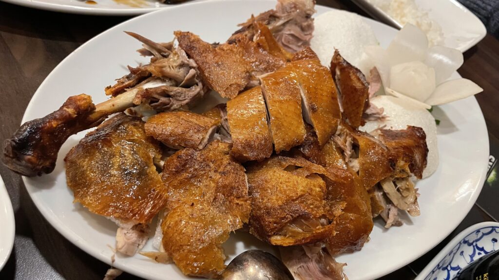 A plate of authentic Peking duck with rice on a table at Restaurant Yung in Frankfurt