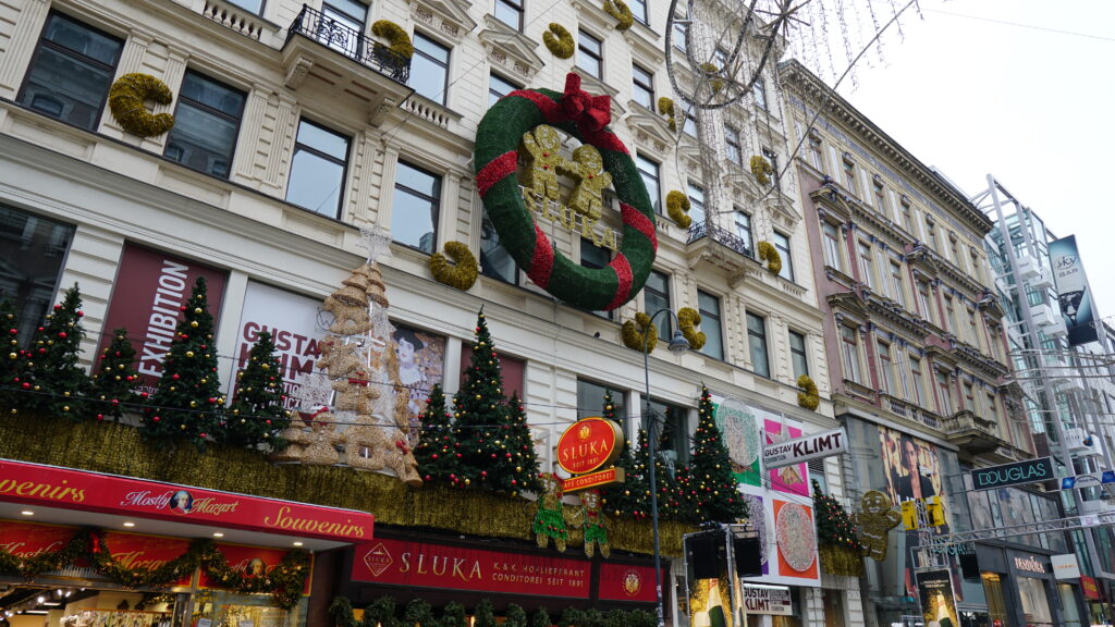 A large building in Vienna decorated with a Christmas wreath.