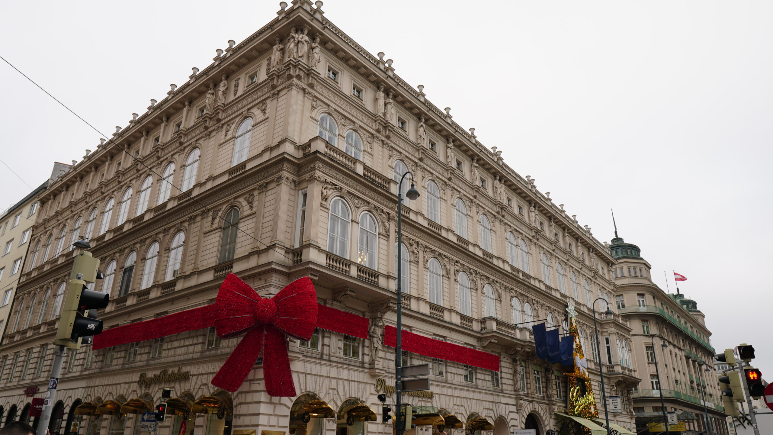 An impressive building in Vienna with a striking red bow that adds a touch of elegance and charm to the scene.