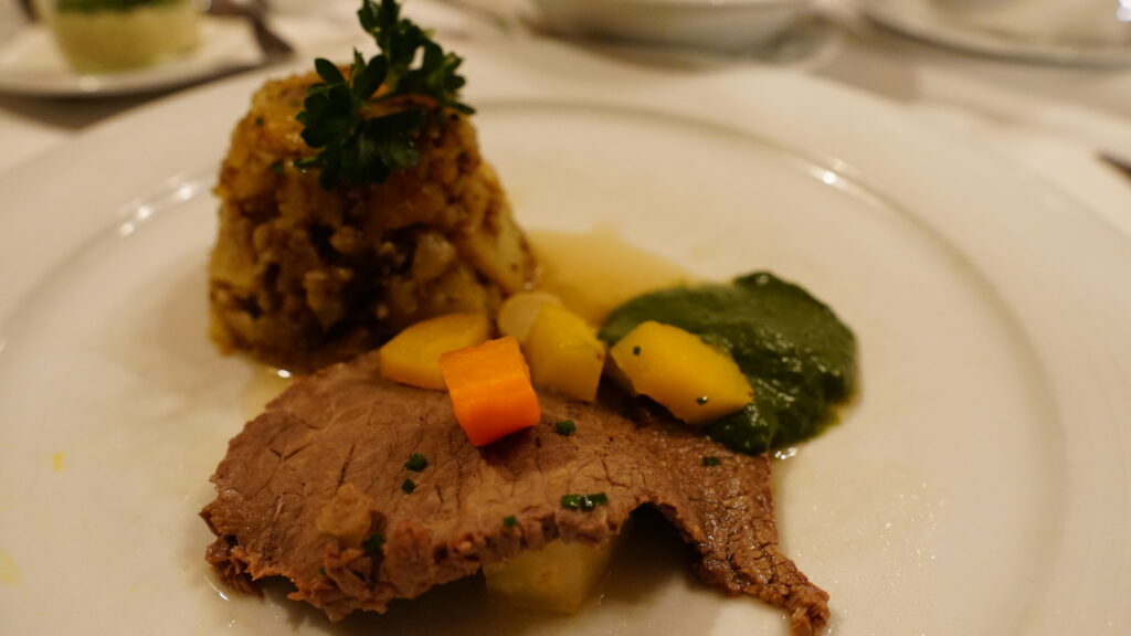 Image of a plate of Tafelspitz with meat and vegetables for our Vienna Travel and Food Guide.