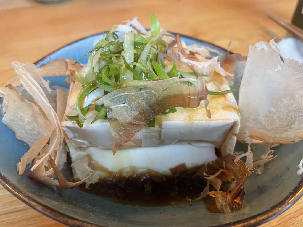 A bowl of Hiyayakko, a dish of fresh cold tofu topped with ginger paste and dried seaweed