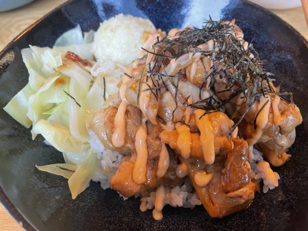 Rice bowl with chicken, vegetables and teriyaki sauce served at a Japanese donburi restaurant in Frankfurt